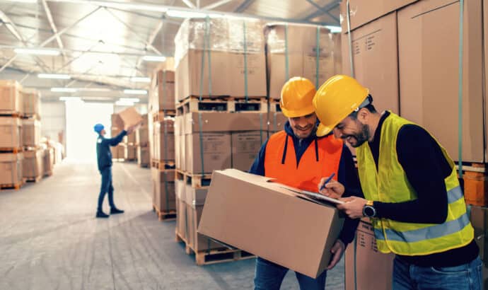 smiling warehouse worker with a package