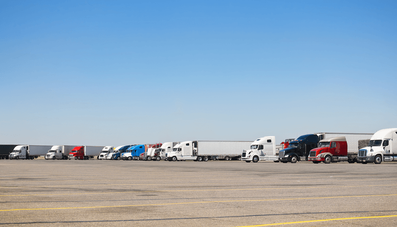 group of semi trucks parked