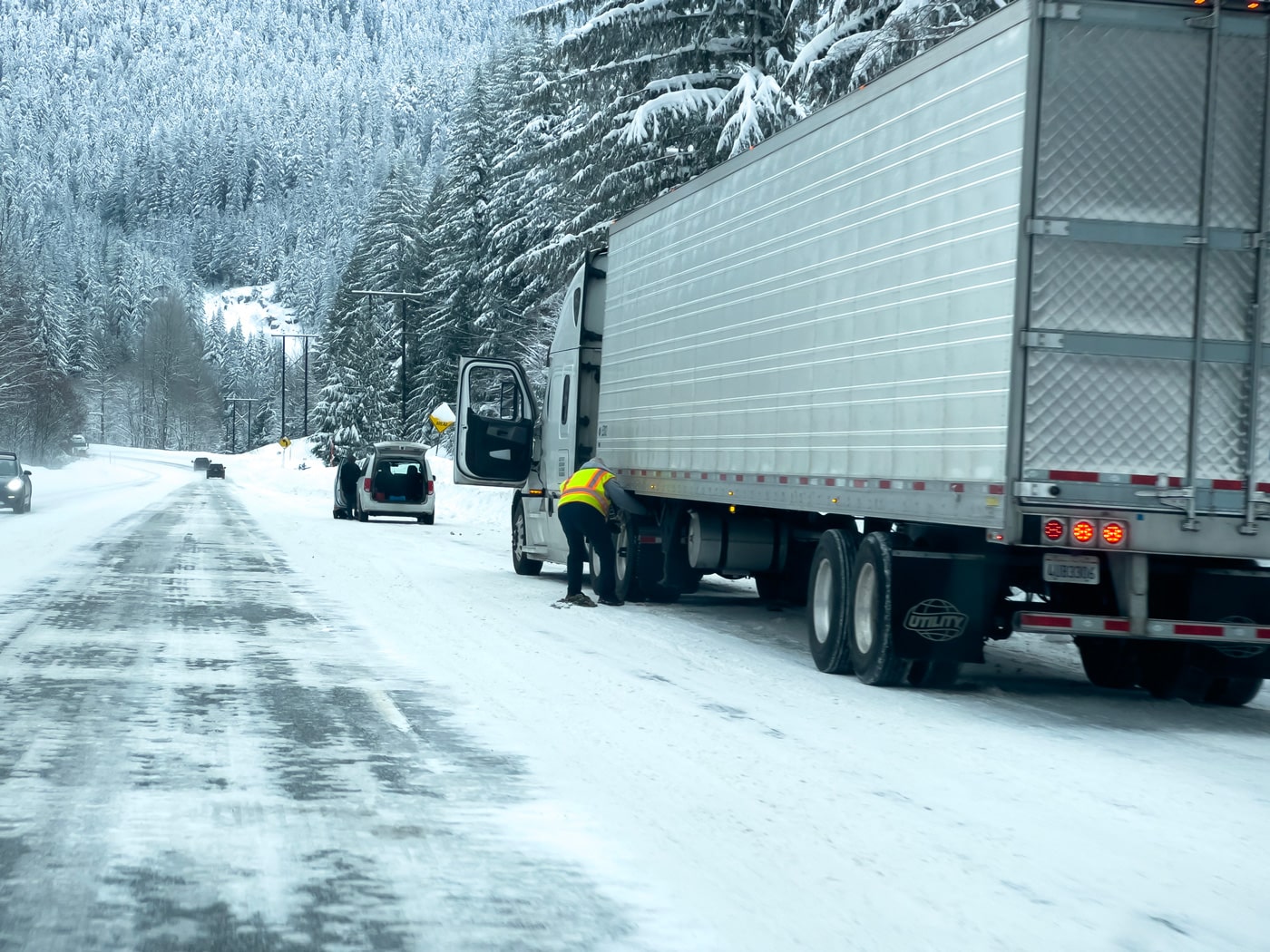 picture of a truck driver stuck in the winter weather