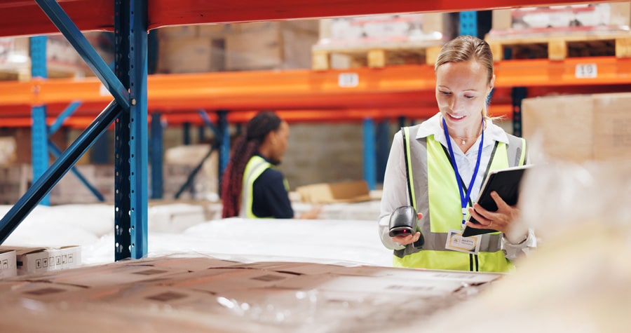 Woman scanning boxes in a warehouse